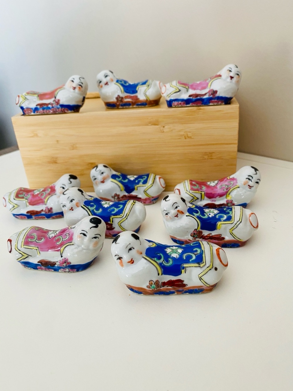 Vintage Japan porcelain “Pillow Baby” chopstick rests, set of 10. Hand-painted